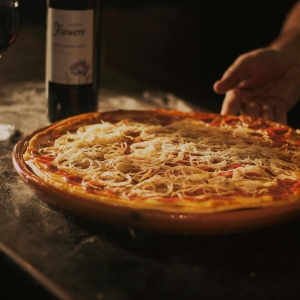 Person Holding Pepperoni Pizza on Tray